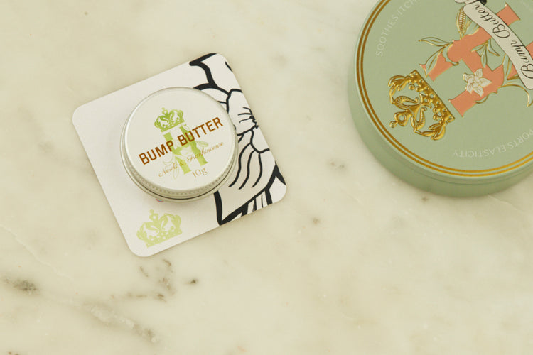 Bump Butter pocket-size tin on a printed card beside the full-size tin