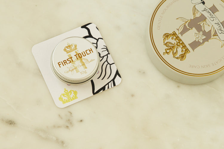 First Touch pocket-size tin on a printed card beside the full-size tin