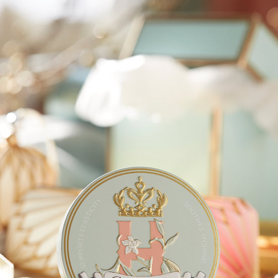 Bump Butter tin on a table beside a glass box and soft white decor