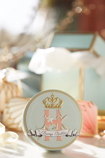 Bump Butter tin on a table beside a glass box and soft white decor