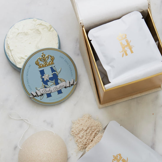 Open ritual box with a Butter in Blue tin, an open tin of butter, soak sachets and a konjac sponge