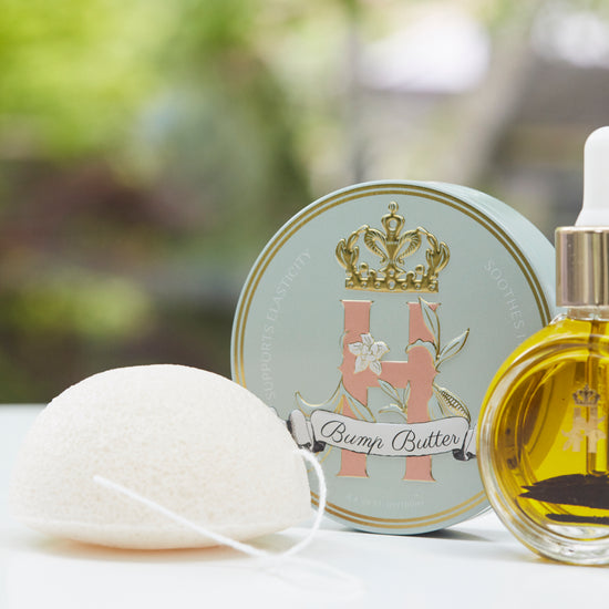 Bump Butter tin, a konjac sponge and a serum bottle outdoors