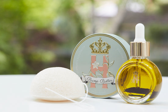 Bump Butter tin, a konjac sponge and a serum bottle outdoors