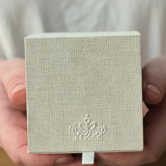 Hands holding the linen-covered Royal Heir ritual box