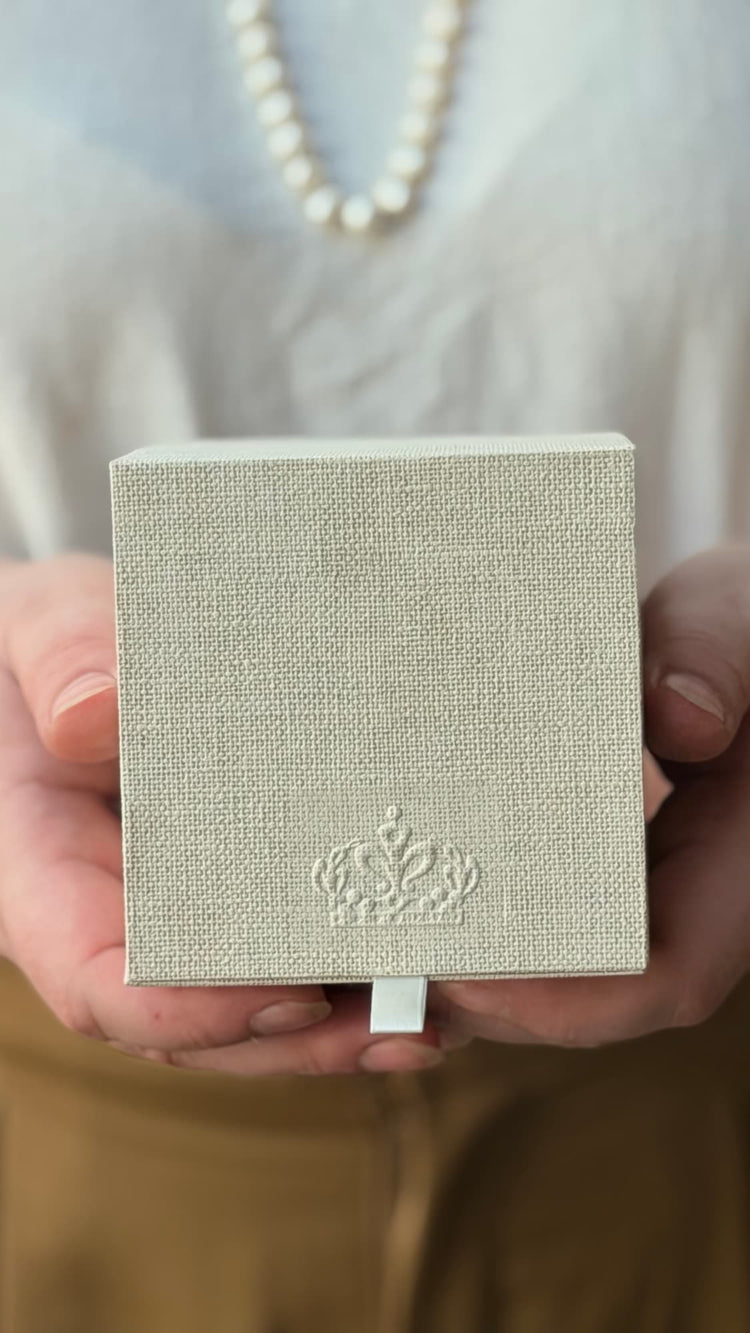 Hands holding the linen-covered Royal Heir ritual box