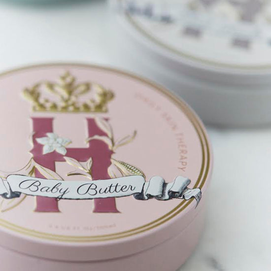 Butter in Pink tin with a gold crown beside a second tin