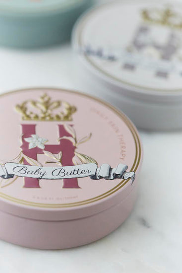 Butter in Pink tin with a gold crown beside a second tin