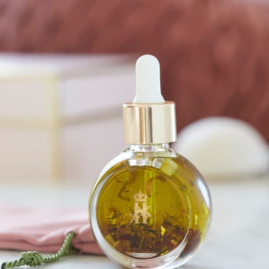Serum bottle with a white dropper in soft focus on a pink blanket
