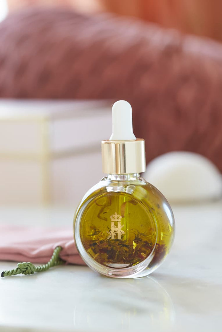 Serum bottle with a white dropper in soft focus on a pink blanket