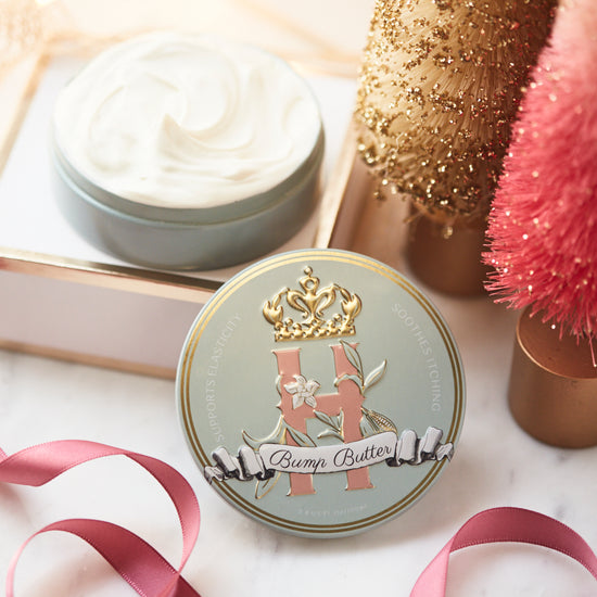 Bump Butter tin with an open tin of whipped butter, a pink decorative tree and gold ornaments