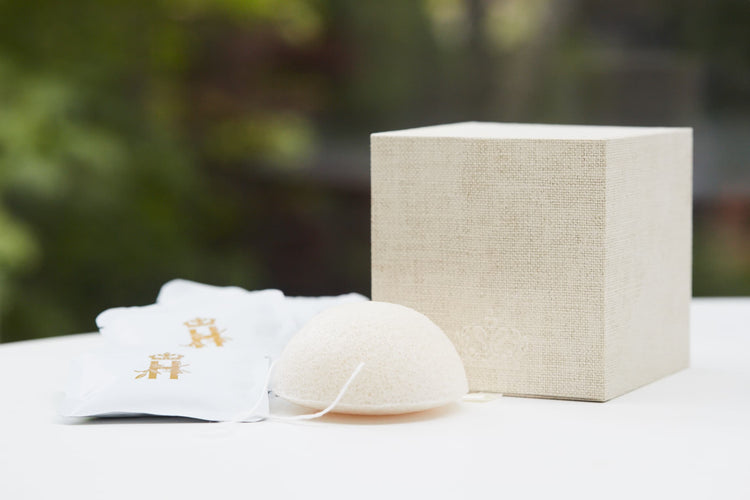 Linen gift box, soak sachets and a konjac sponge outdoors